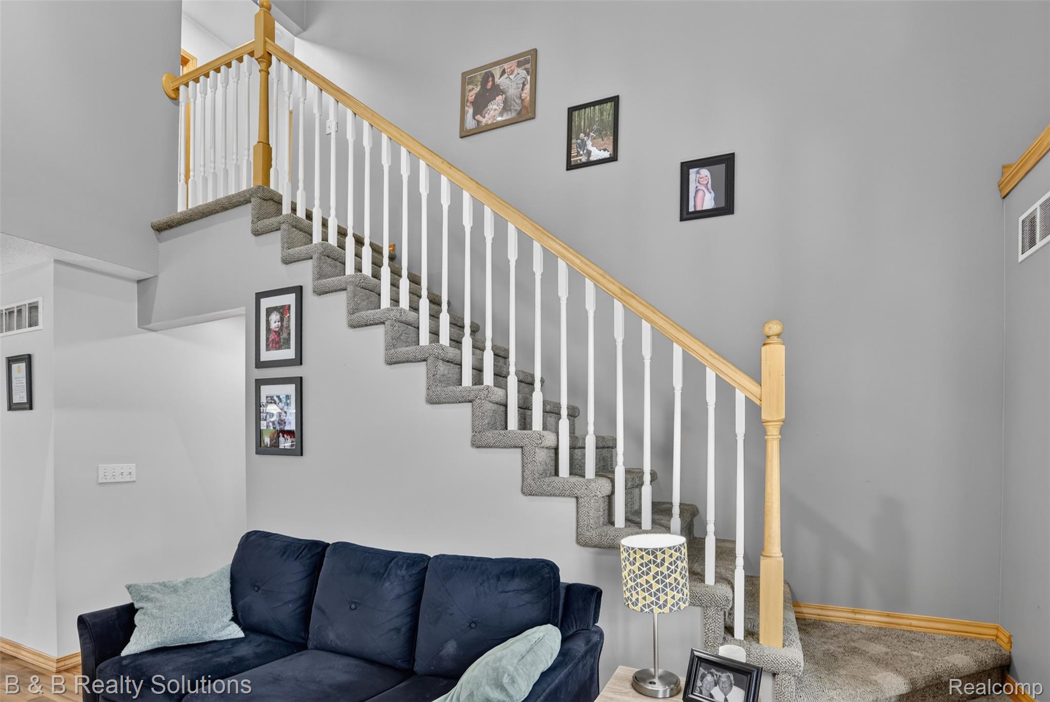 3097 East Burnside Road North Branch, MI 48461 - Photo 24 of 52 Carpeted staircase with white balusters and natural wood handrail