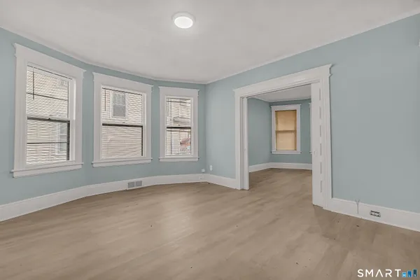 an empty room with windows and closet