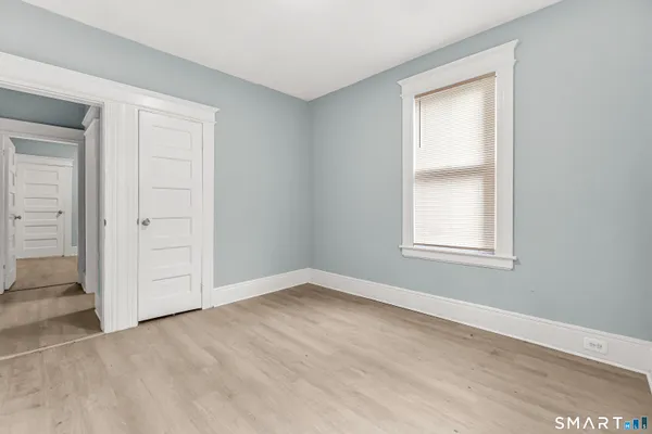 an empty room with windows and closet