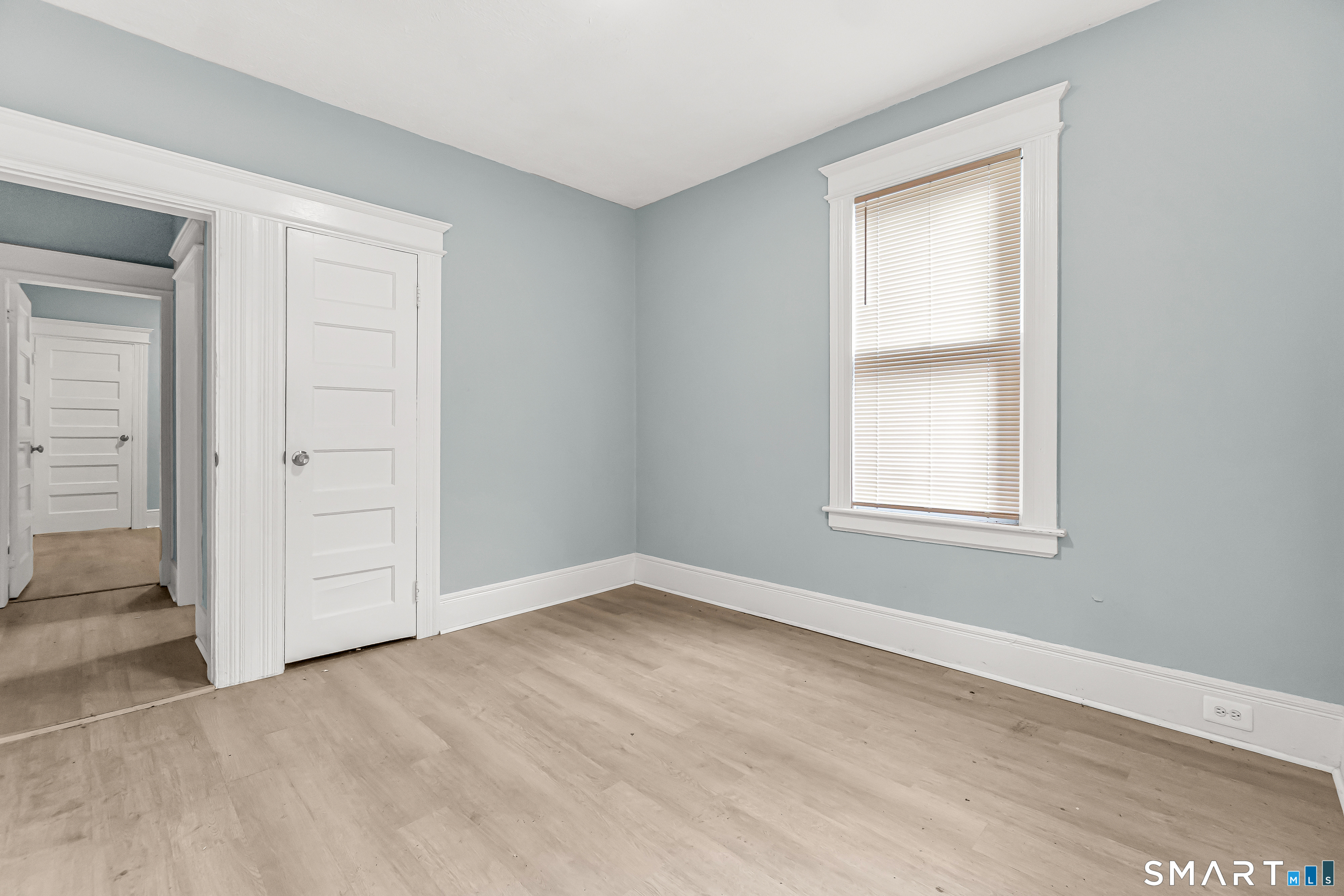 105 Carleton Avenue Bridgeport, CT 06604 - Photo 19 of 26 an empty room with windows and closet