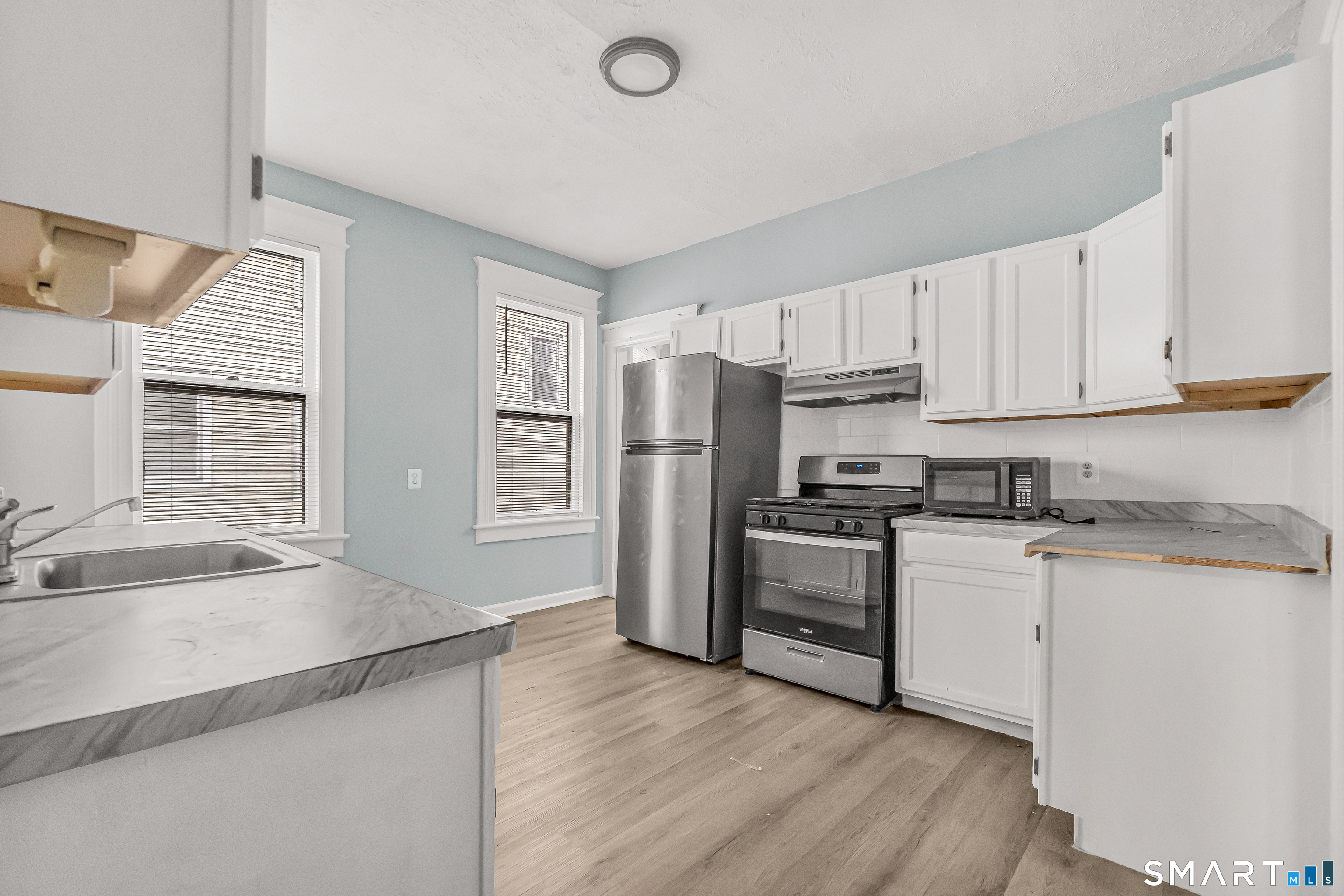 105 Carleton Avenue Bridgeport, CT 06604 - Photo 23 of 26 a kitchen with stainless steel appliances granite countertop a refrigerator and a sink