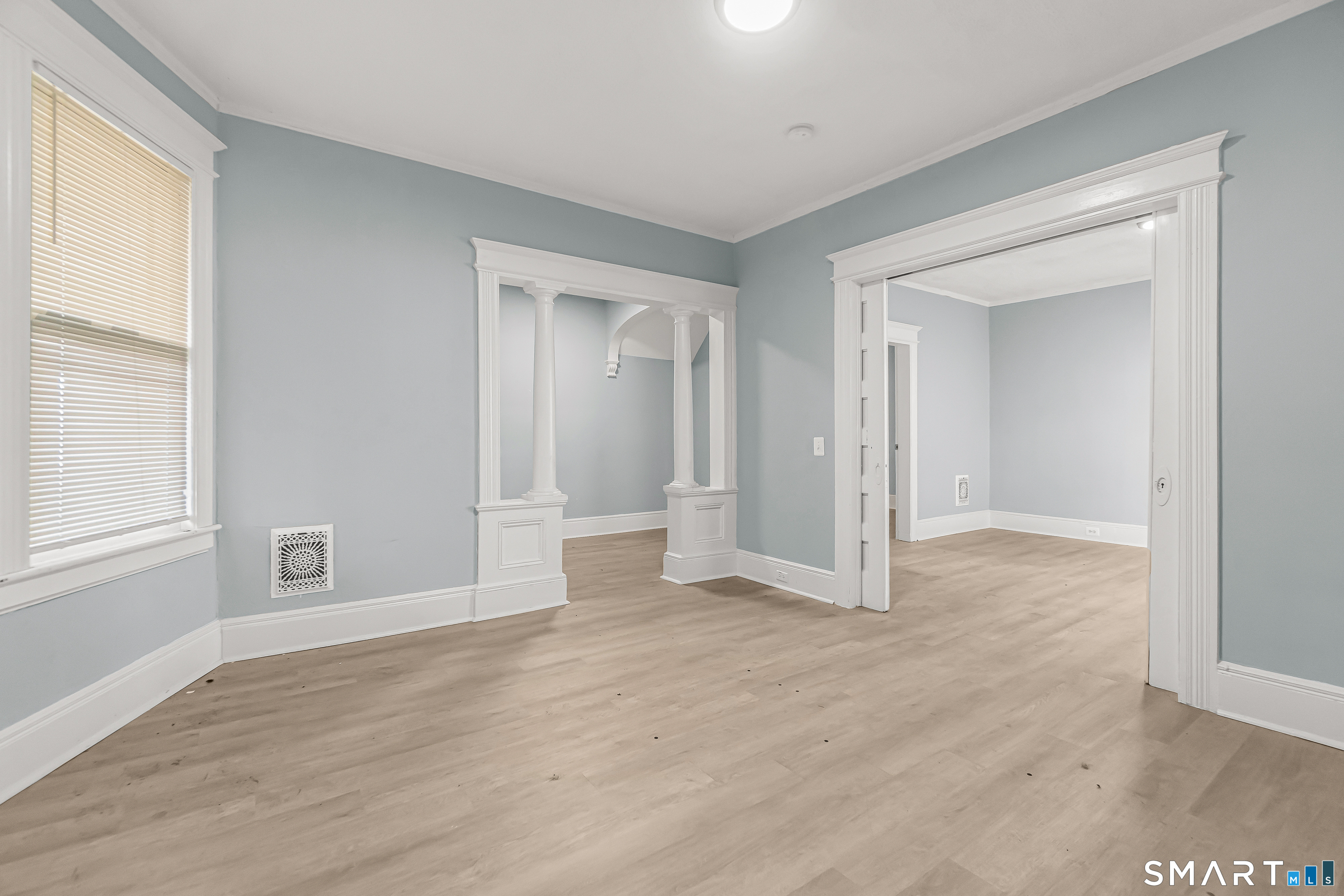 105 Carleton Avenue Bridgeport, CT 06604 - Photo 6 of 26 a view of an empty room with wooden floor and a window
