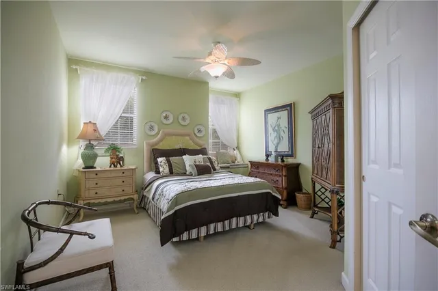 a bedroom with a bed gym equipment and large window