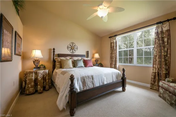 a bed sitting in a bedroom next to a window
