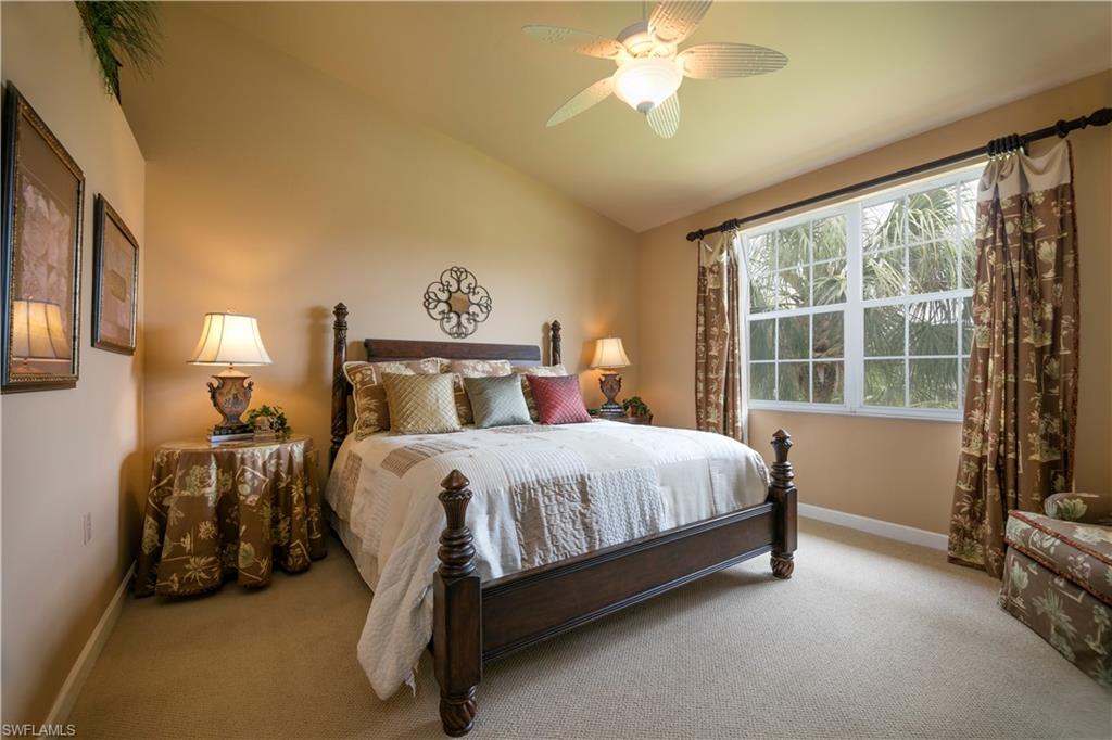 3048 Horizon Lane, Unit 1104 Naples, FL 34109 - Photo 12 of 16 a bed sitting in a bedroom next to a window