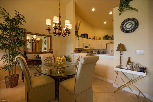a dining room with furniture and a chandelier