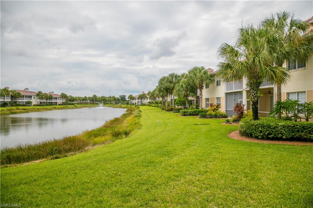 3048 Horizon Lane, Unit 1104 Naples, FL 34109 - Photo 10 of 16 a view of a lake with houses in the background