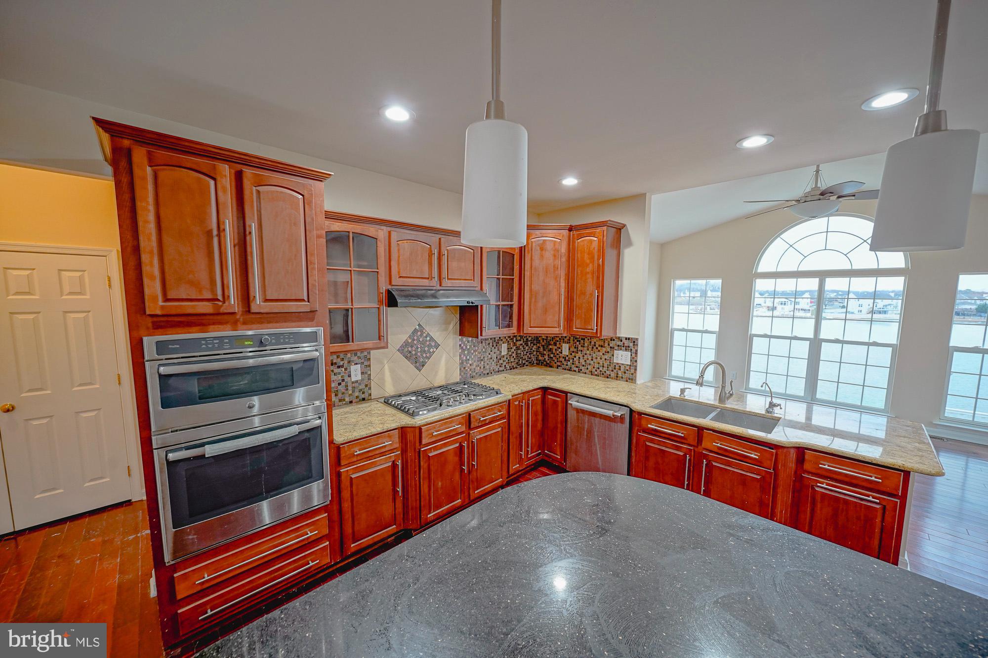 67 Mullen Drive Sicklerville, NJ 08081 - Photo 21 of 57 a kitchen with stainless steel appliances granite countertop a stove and a sink