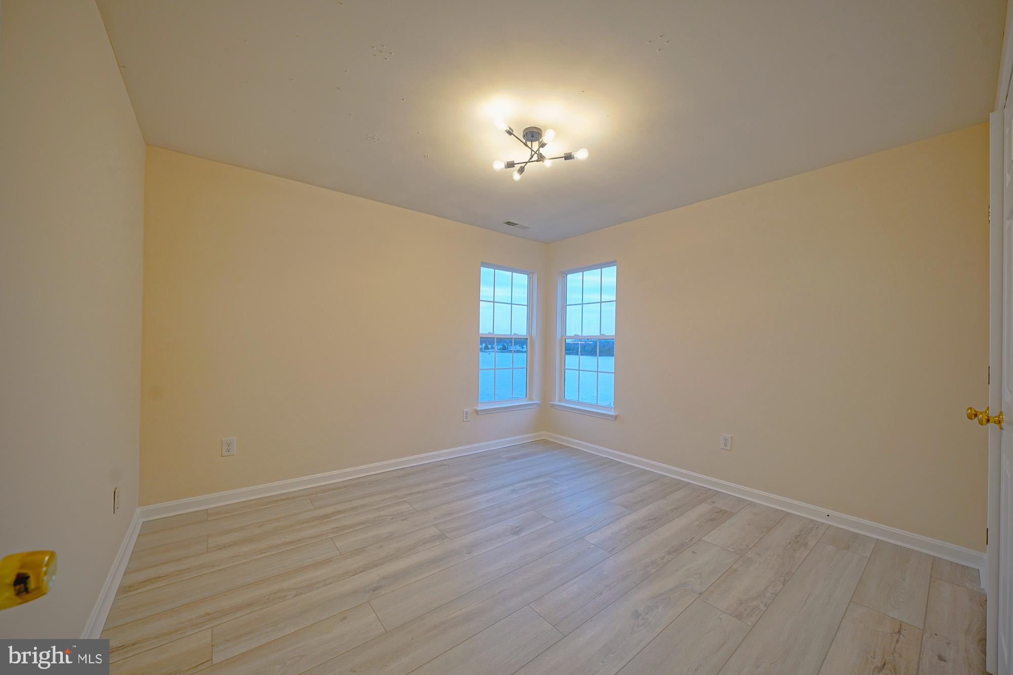 67 Mullen Drive Sicklerville, NJ 08081 - Photo 47 of 57 wooden floor in an empty room with a window