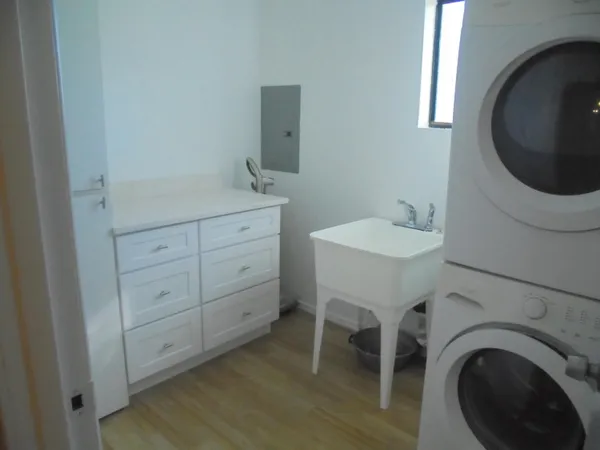 a spacious bathroom with a toilet a sink and mirror