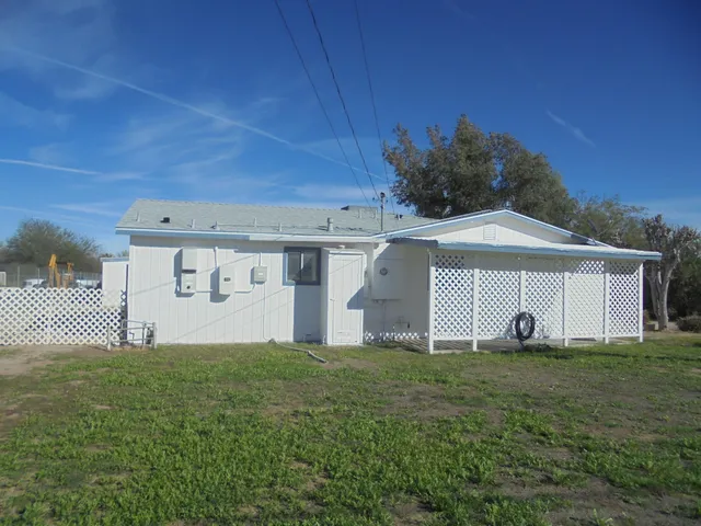 a view of a house with a yard and a garage