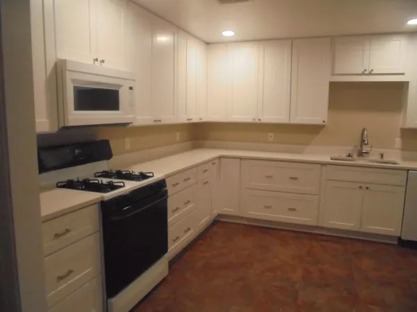 a kitchen with a stove a sink and a microwave