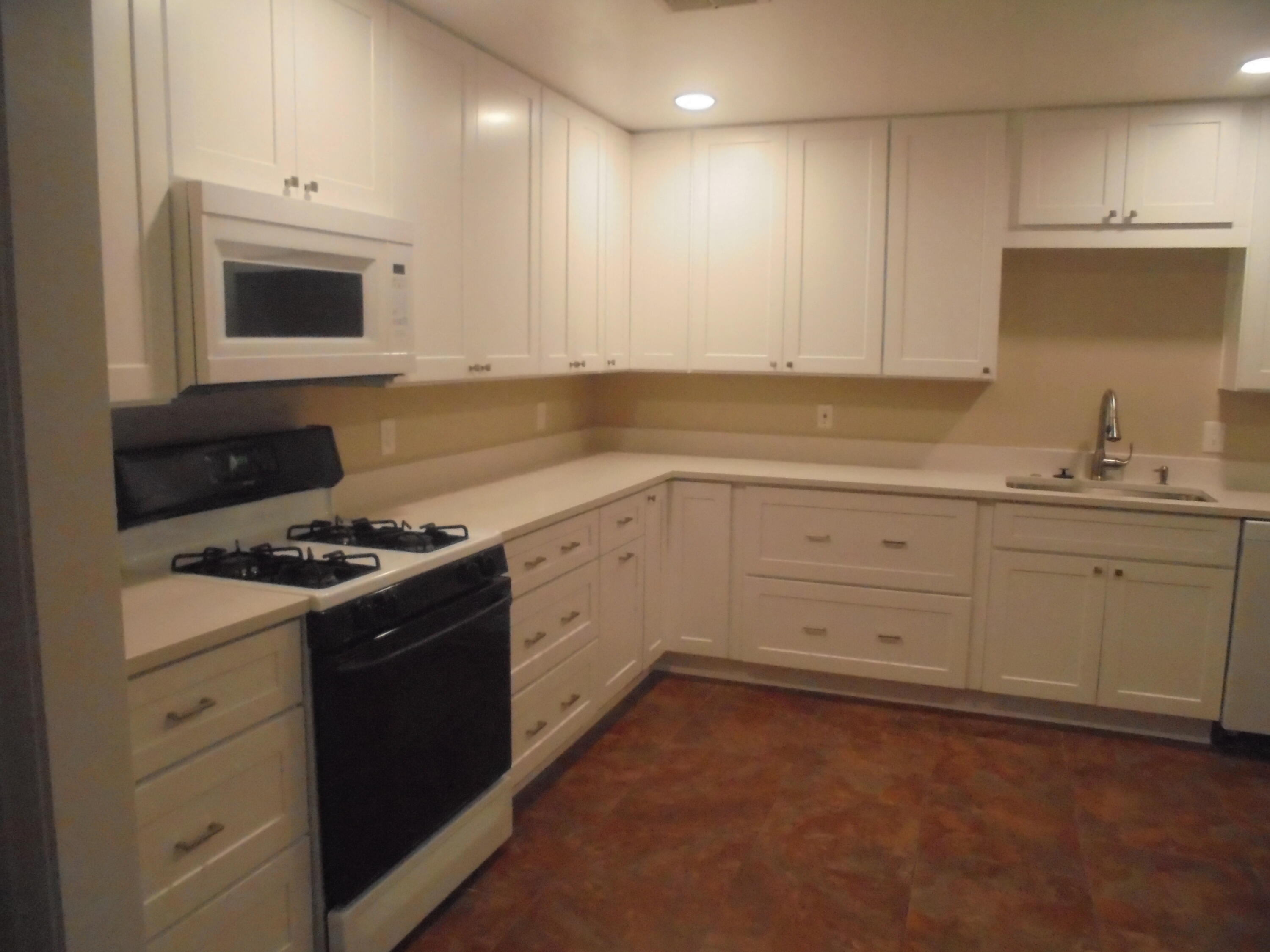 2274 Riviera Drive Blythe, CA 92225 - Photo 4 of 22 a kitchen with a stove a sink and a microwave