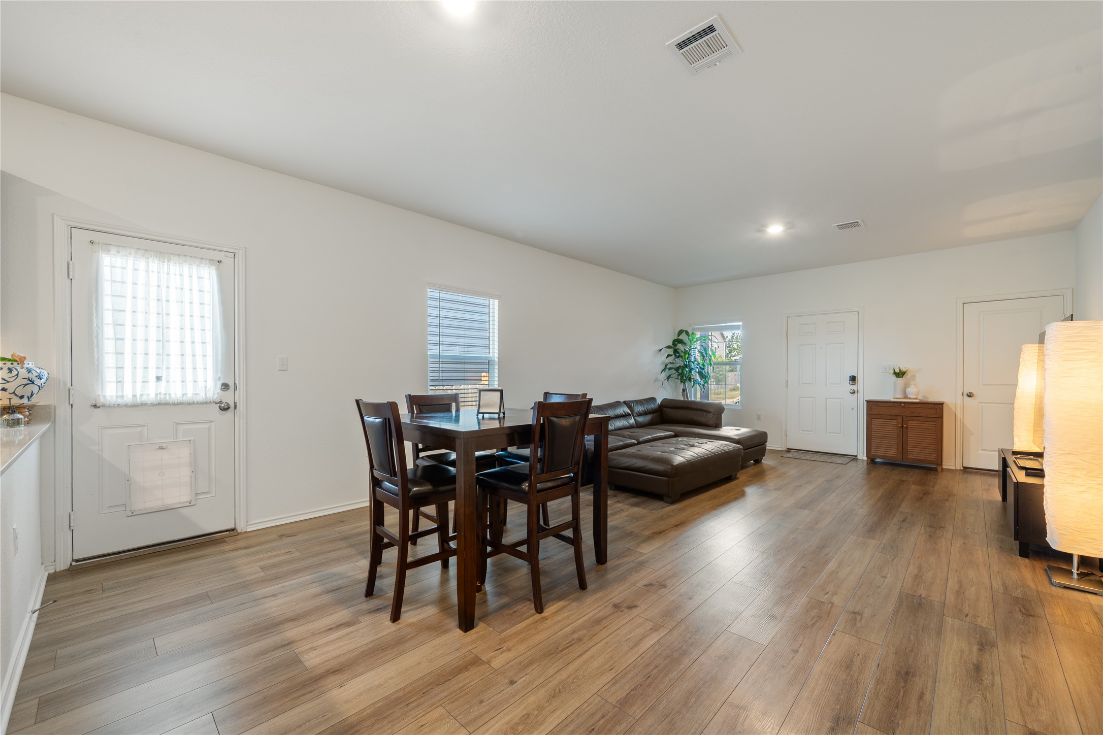 14404 Berning Road Manor, TX 78653 - Photo 9 of 38 Hardwood-style flooring and recessed lighting define this inviting open living area.