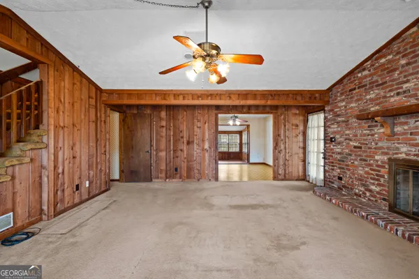 a view of a livingroom with a fireplace and window