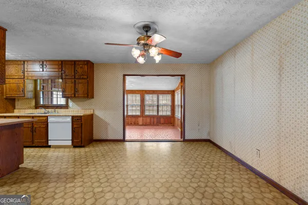 a view of kitchen with granite countertop cabinets and appliances