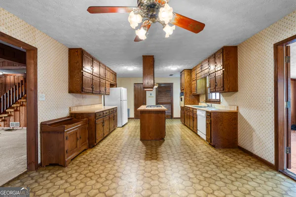 a kitchen with stainless steel appliances granite countertop a sink and a stove