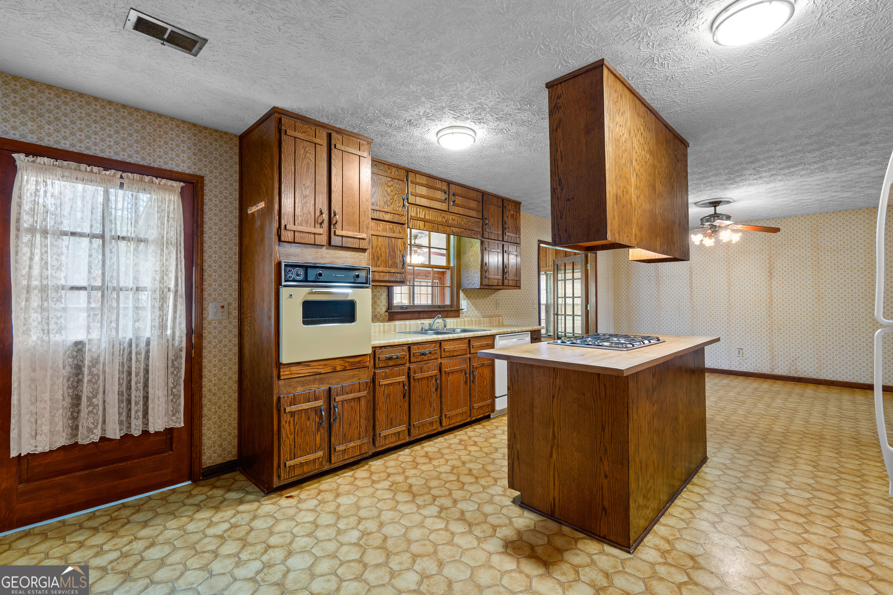 447 Adams Road Fayetteville, GA 30214 - Photo 19 of 52 a kitchen with stainless steel appliances granite countertop a stove a sink and a refrigerator