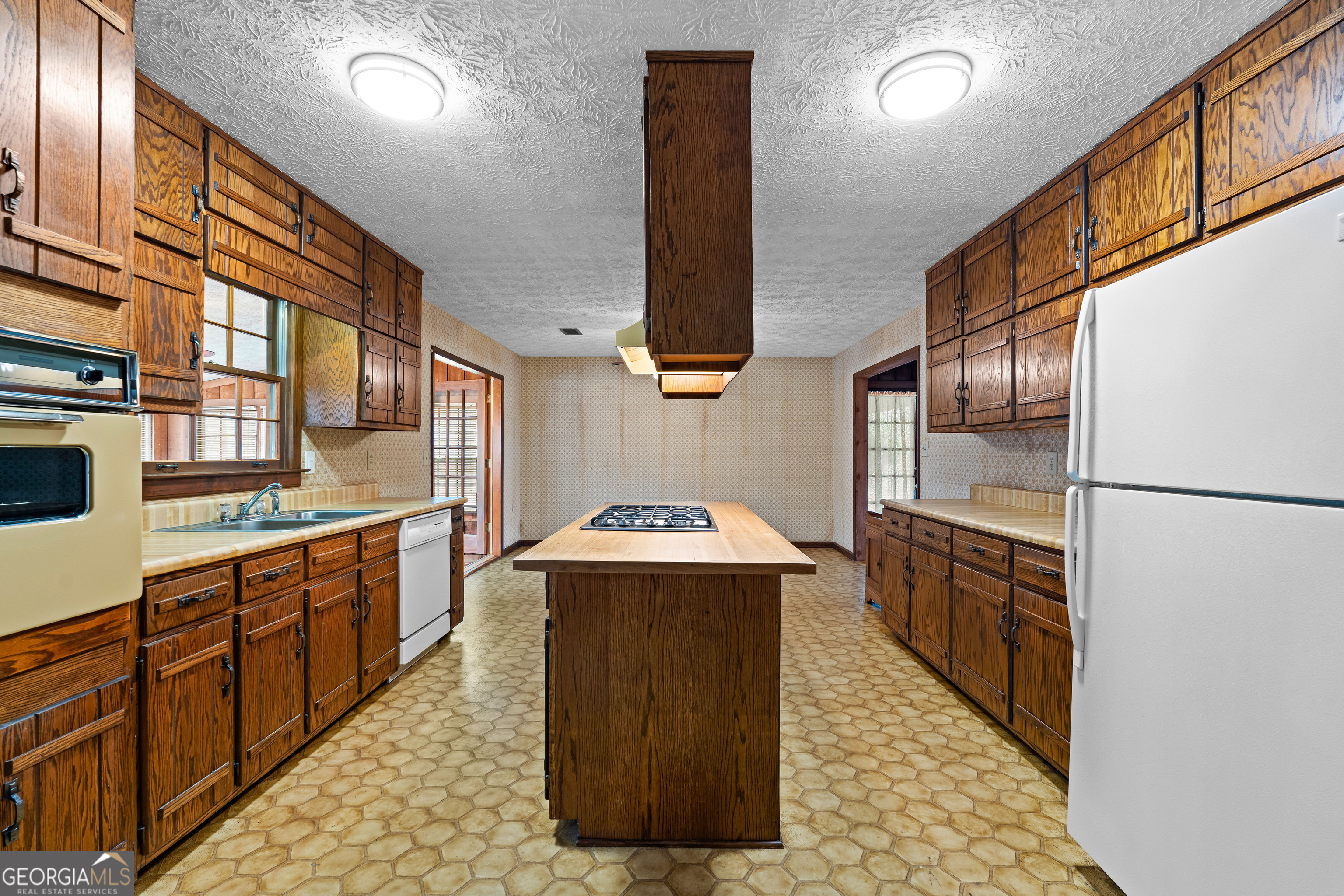 447 Adams Road Fayetteville, GA 30214 - Photo 21 of 52 a kitchen with stainless steel appliances granite countertop a stove a sink and a refrigerator