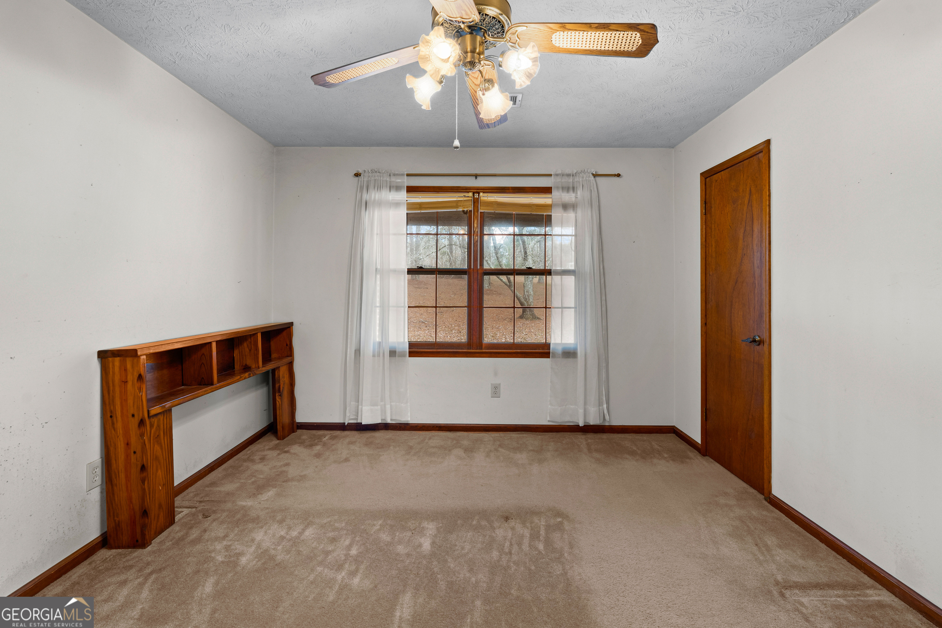 447 Adams Road Fayetteville, GA 30214 - Photo 25 of 52 an empty room with chandelier fan and windows