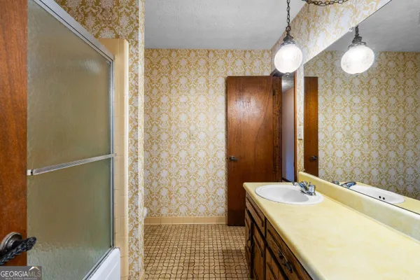 a bathroom with a toilet a sink and shower