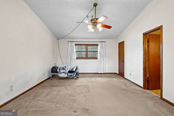 a view of a room with a ceiling fan