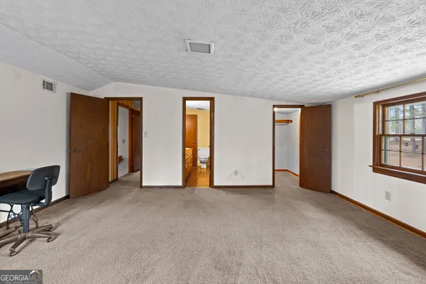 a bathroom with a granite countertop sink a toilet and shower