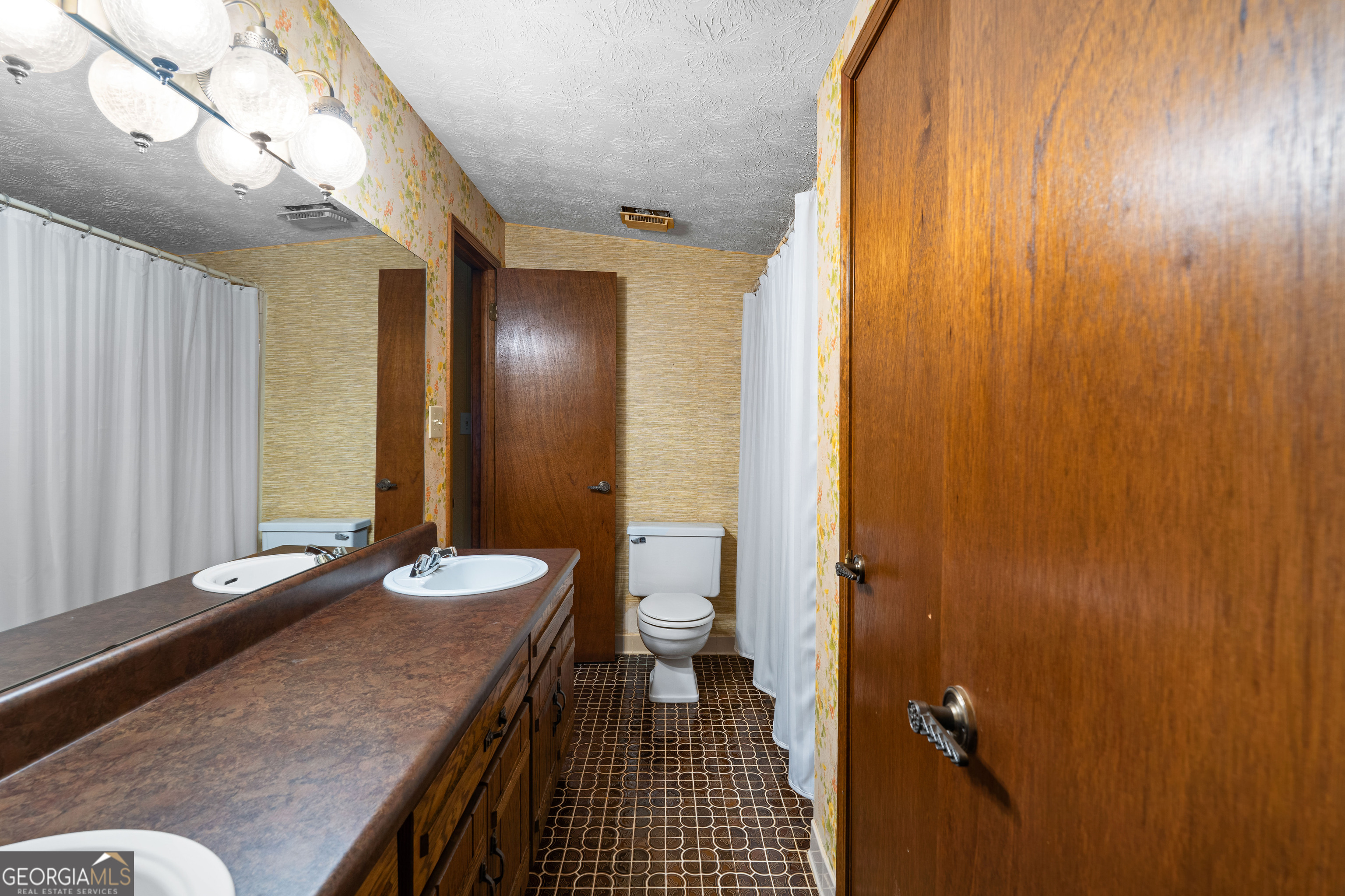 447 Adams Road Fayetteville, GA 30214 - Photo 43 of 52 a bathroom with a granite countertop sink a toilet and shower
