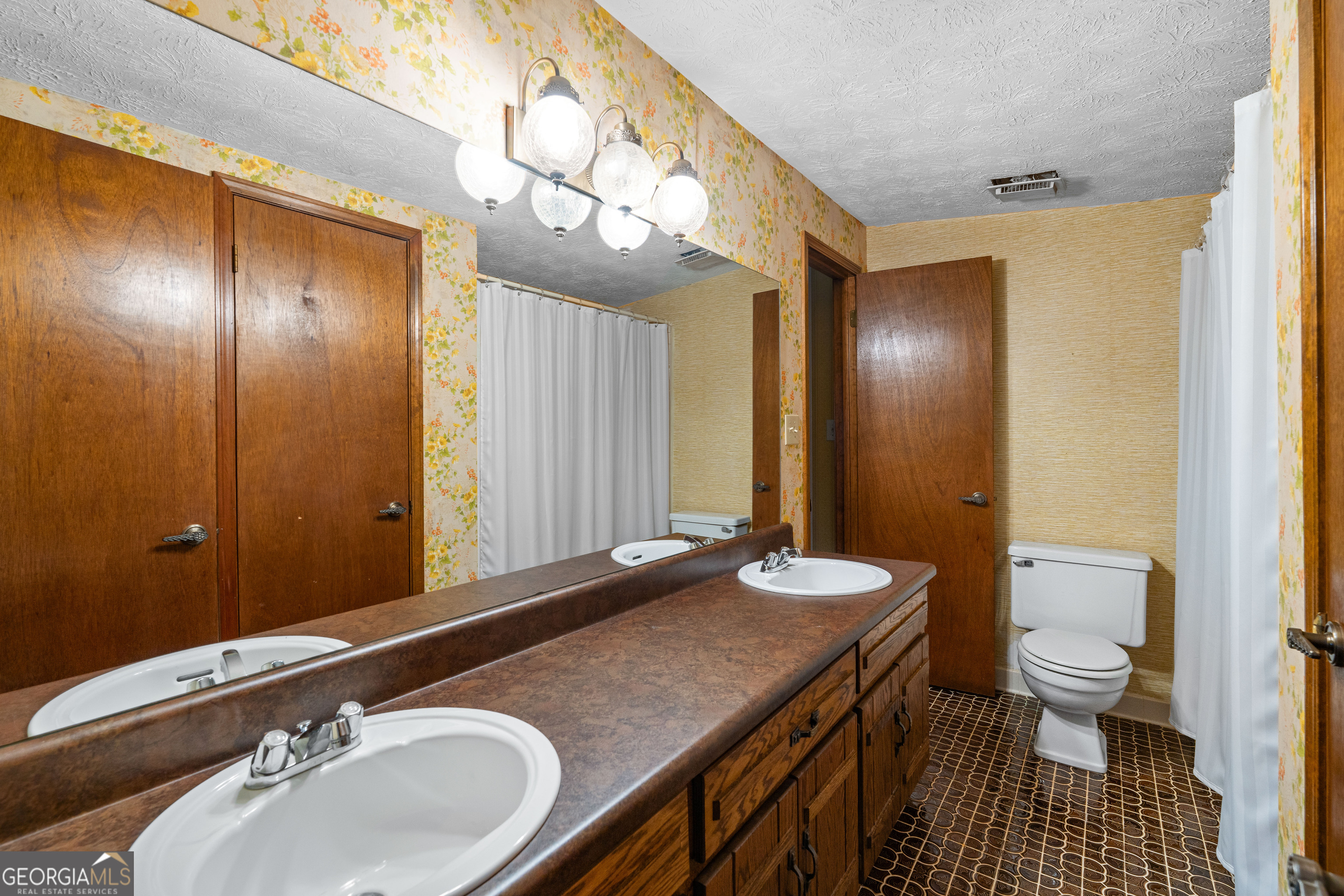 447 Adams Road Fayetteville, GA 30214 - Photo 44 of 52 a bathroom with a sink a toilet and a mirror