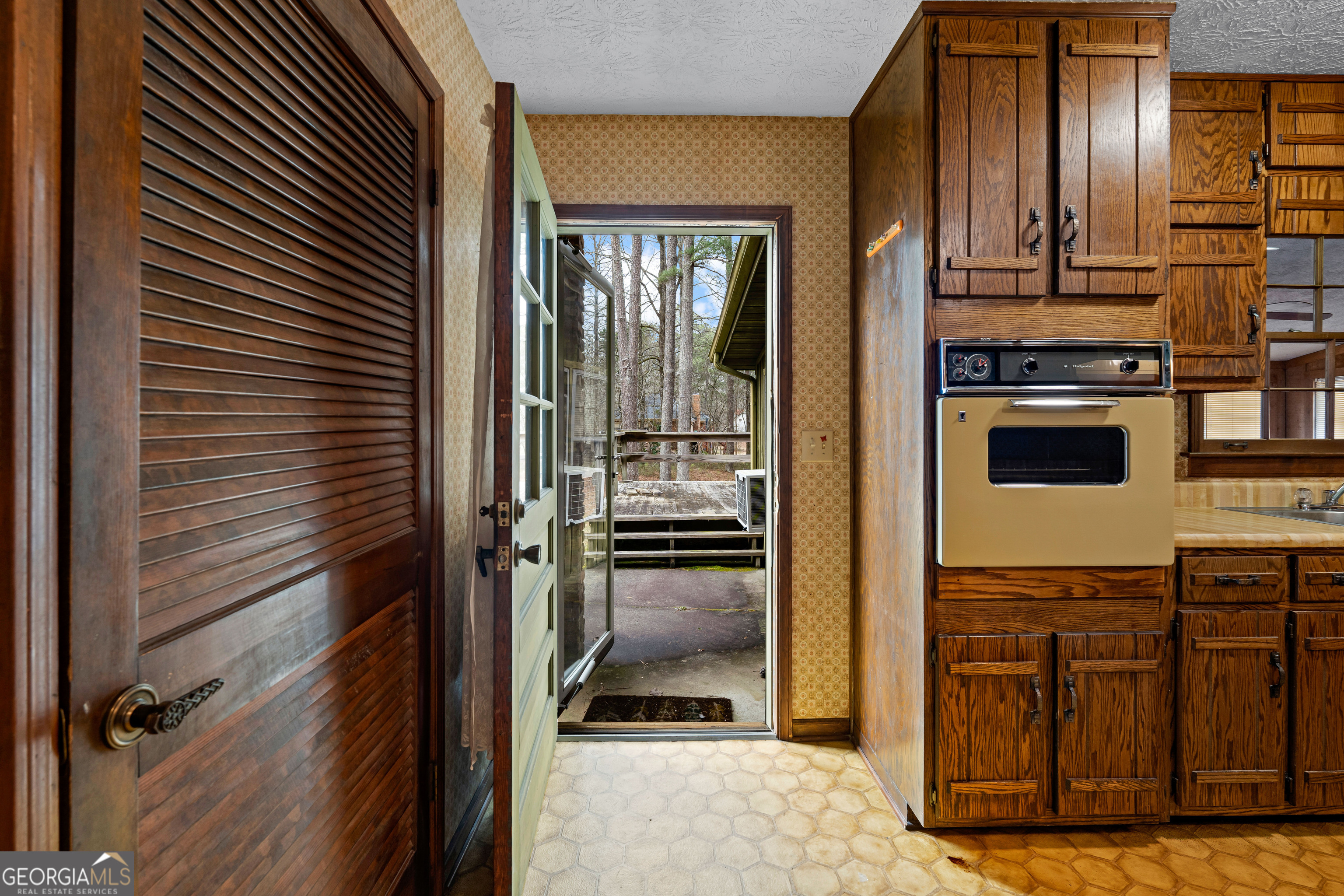 447 Adams Road Fayetteville, GA 30214 - Photo 47 of 52 a view of a kitchen from the hallway