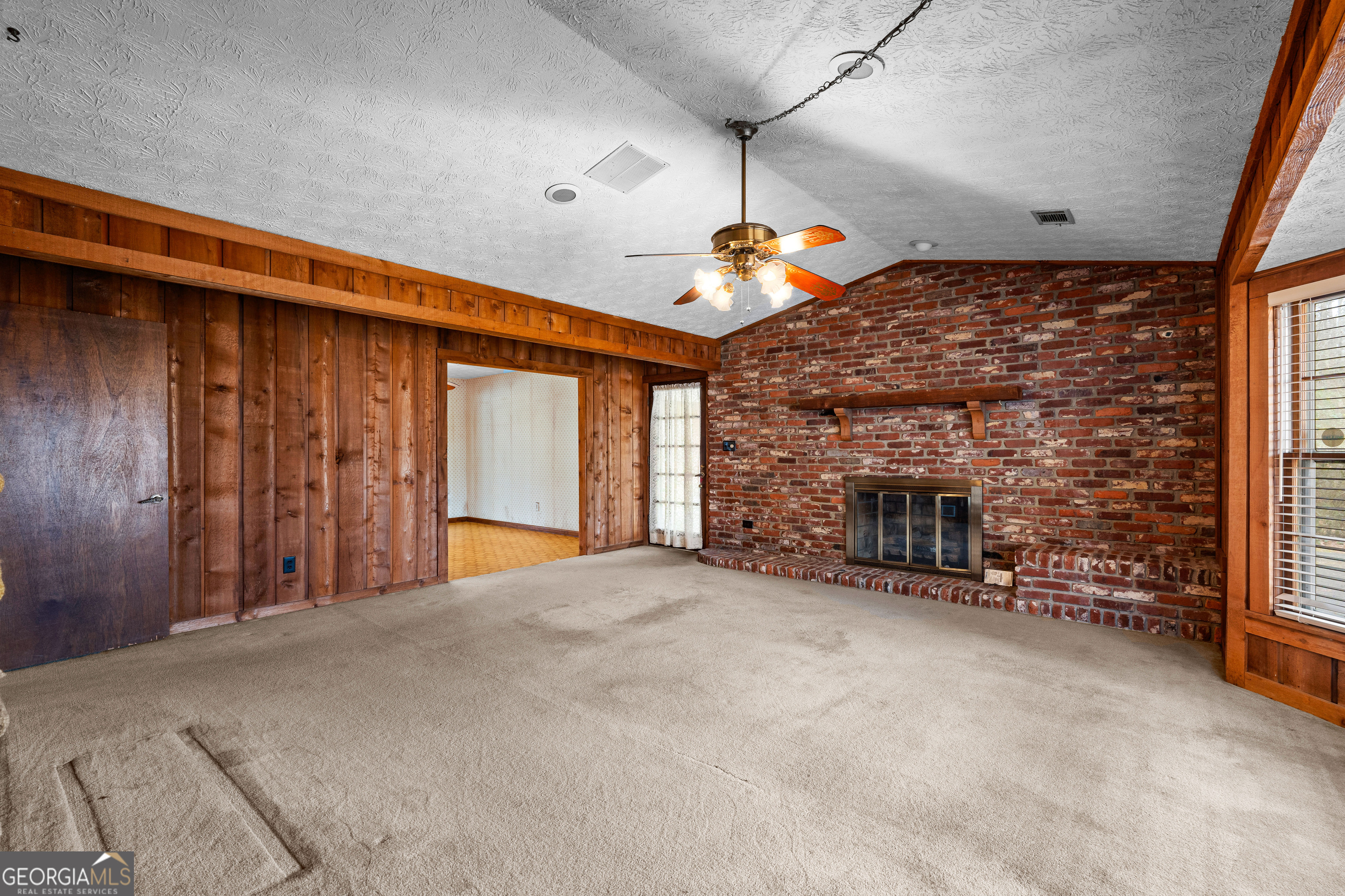 447 Adams Road Fayetteville, GA 30214 - Photo 10 of 52 a large room with fireplace chandelier and windows