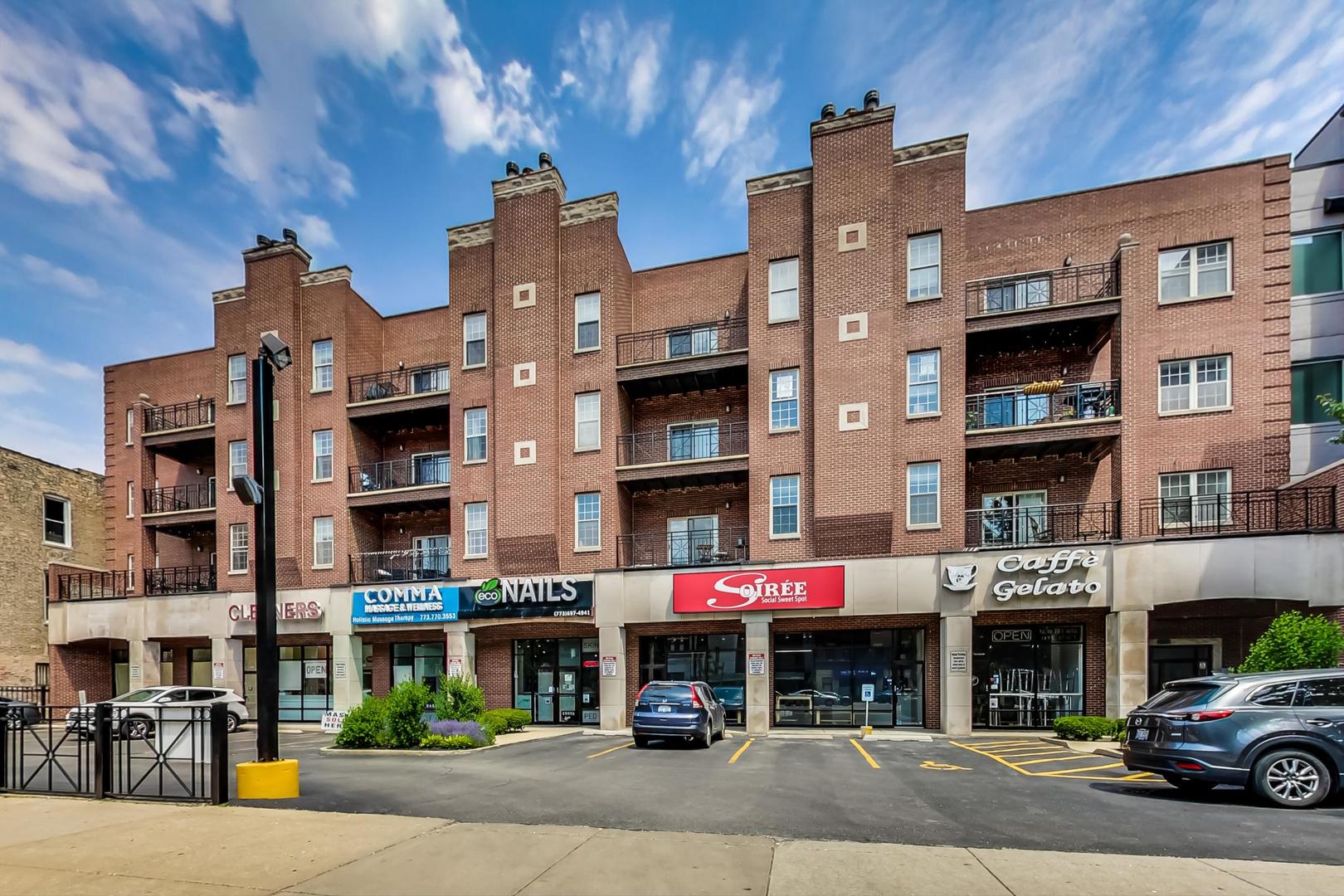 2032 West Division Street, Unit 301N Chicago, IL 60622 - Photo 1 of 12 a front view of multi story residential apartment building with retail shops