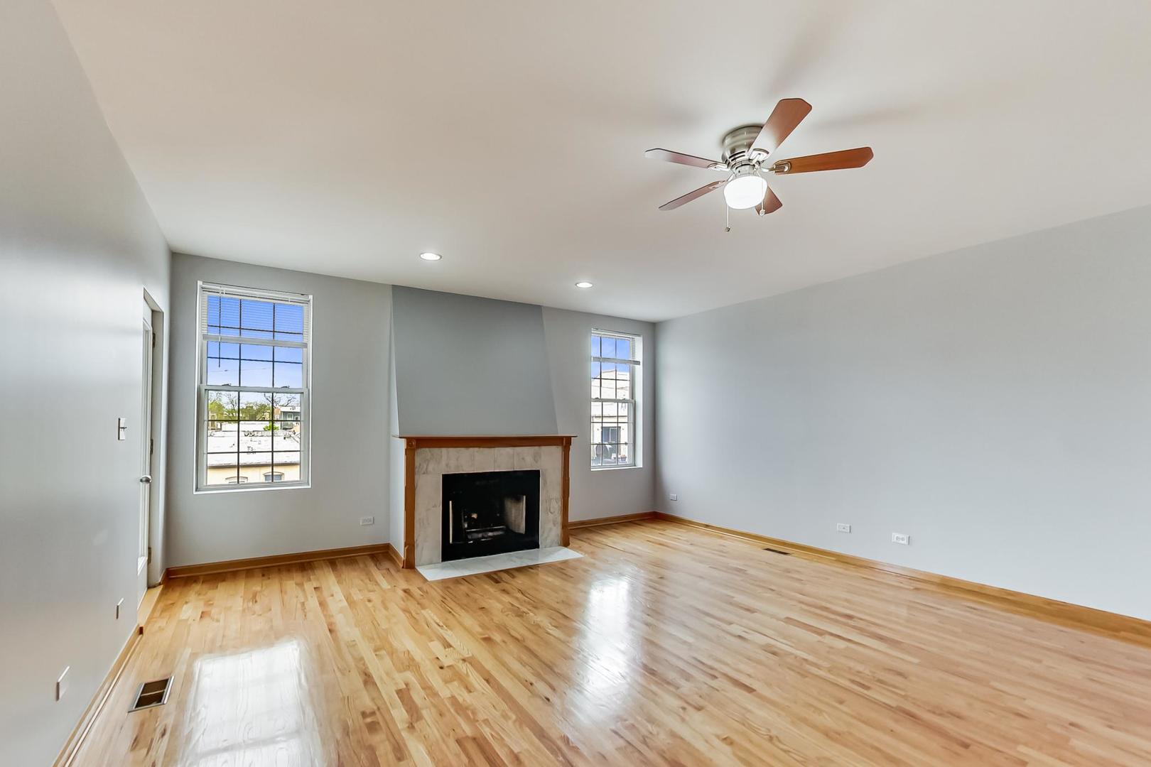 2032 West Division Street, Unit 301N Chicago, IL 60622 - Photo 3 of 12 an empty room with windows fireplace and a sink