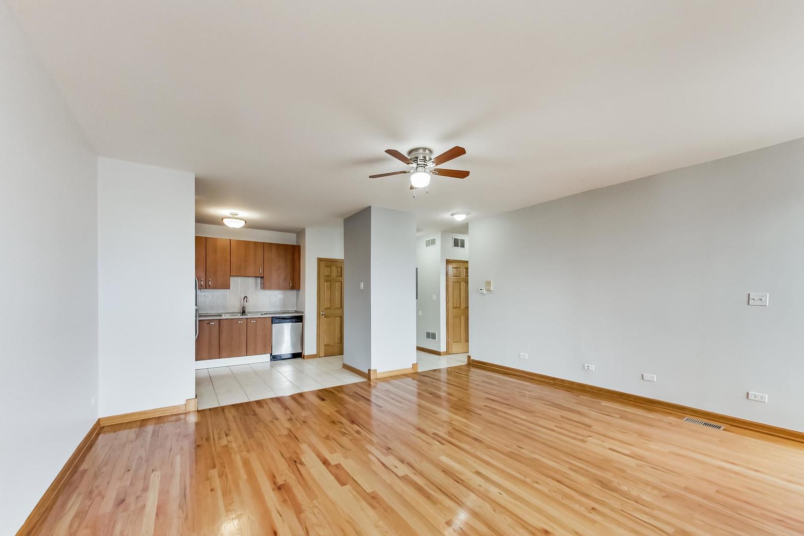2032 West Division Street, Unit 301N Chicago, IL 60622 - Photo 4 of 12 a view of an empty room and wooden floor