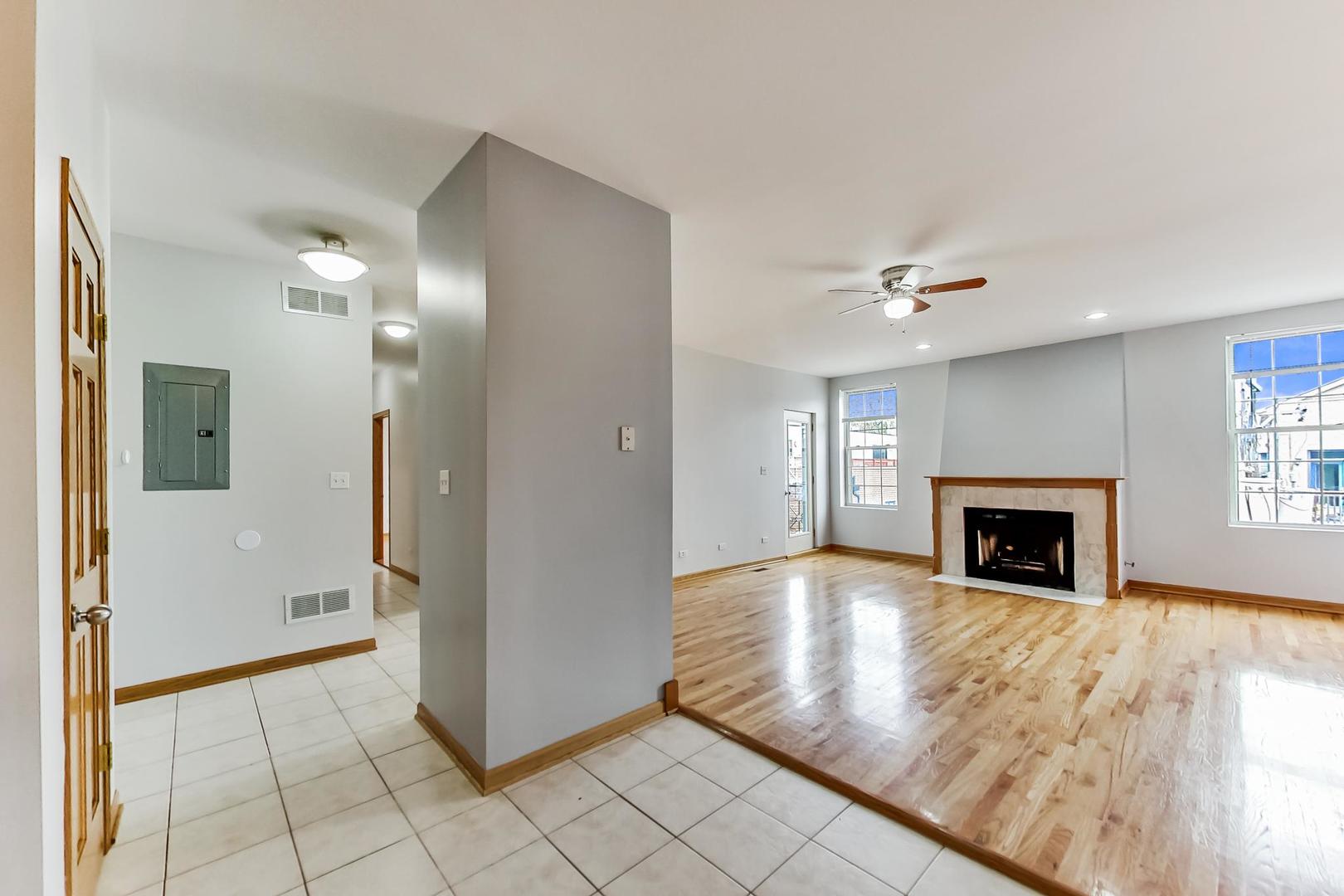 2032 West Division Street, Unit 301N Chicago, IL 60622 - Photo 7 of 12 a view of a livingroom with wooden floor and a fireplace