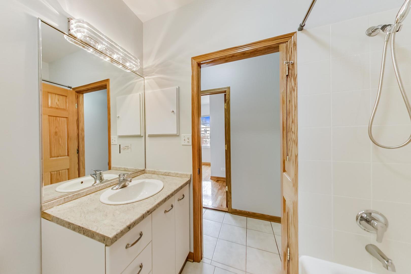 2032 West Division Street, Unit 301N Chicago, IL 60622 - Photo 8 of 12 a bathroom with a sink and a mirror