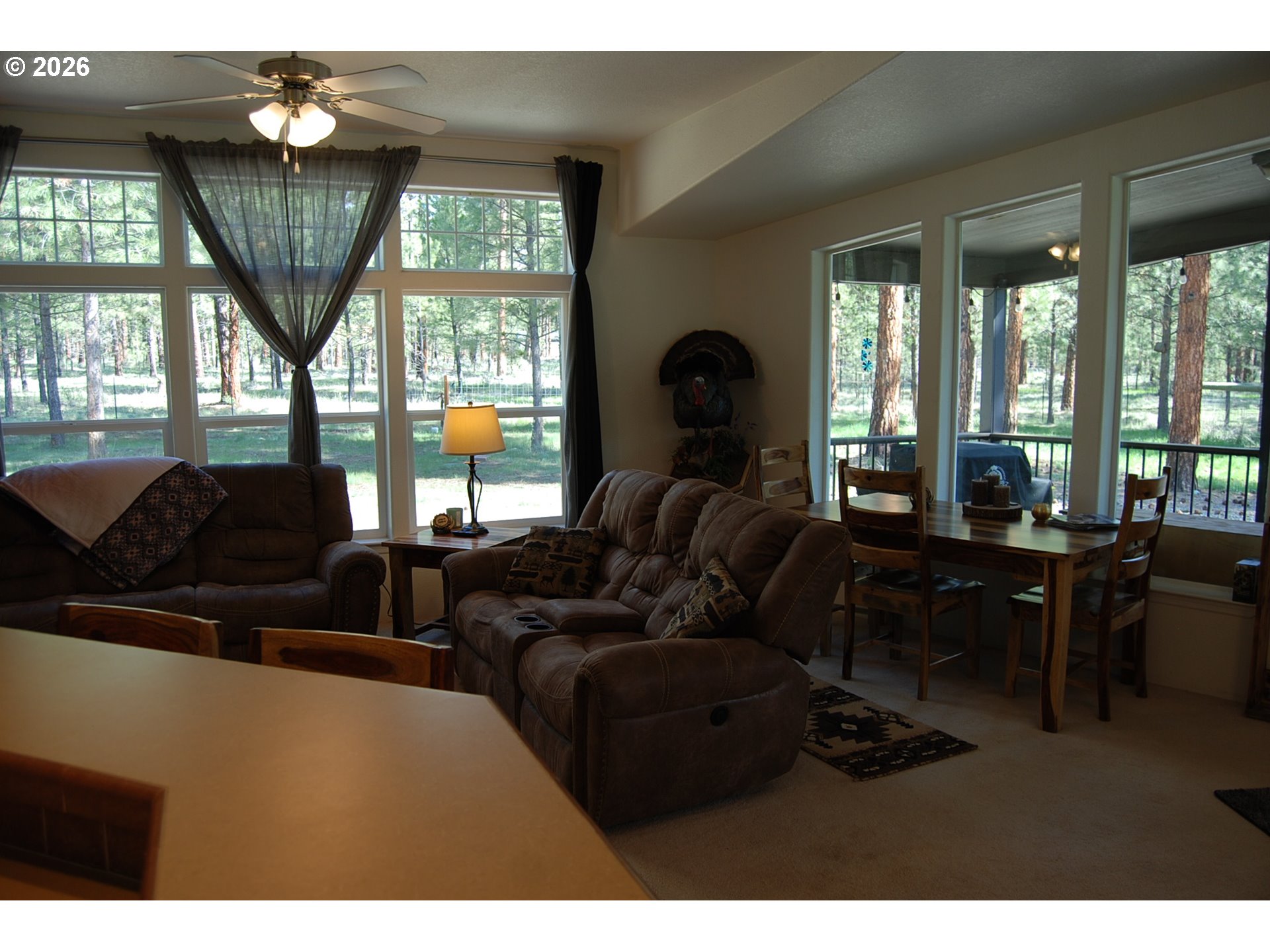 38987 Deer Creek Road Baker City, OR 97814 - Photo 12 of 45 a living room with furniture a window and a dining table