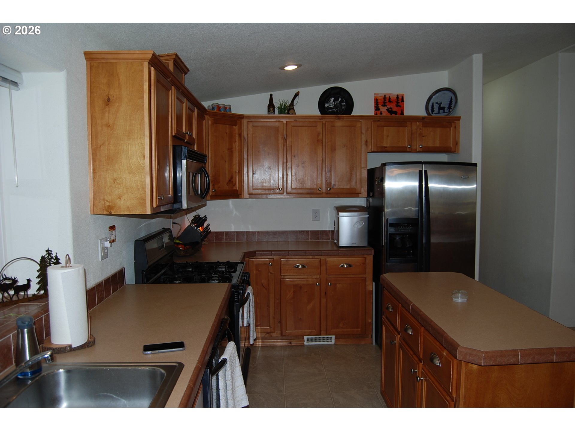 38987 Deer Creek Road Baker City, OR 97814 - Photo 13 of 45 a kitchen with stainless steel appliances a sink cabinets and wooden floor