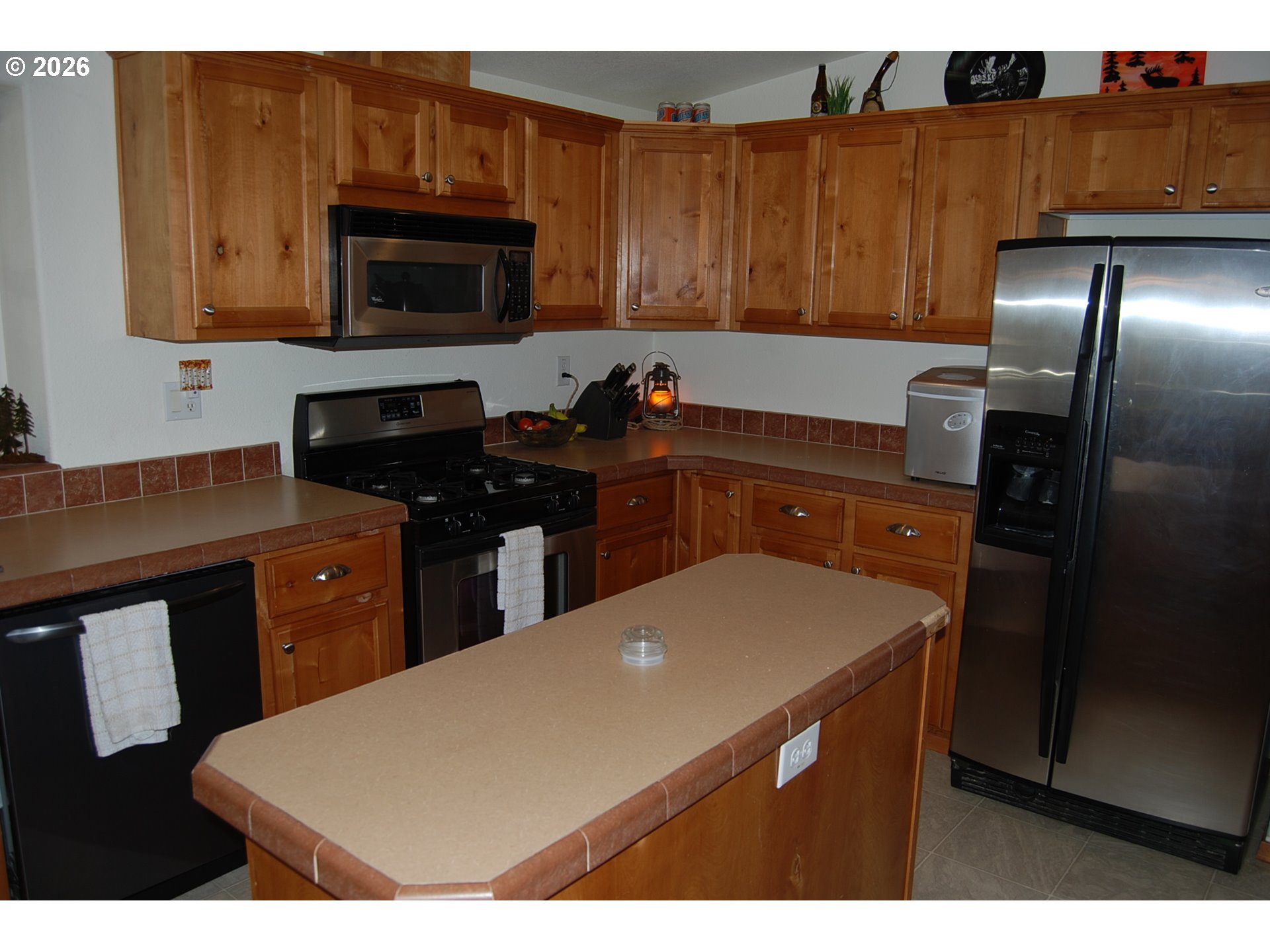 38987 Deer Creek Road Baker City, OR 97814 - Photo 16 of 45 a kitchen with stainless steel appliances a sink a stove a microwave a refrigerator a cabinets and wooden floor