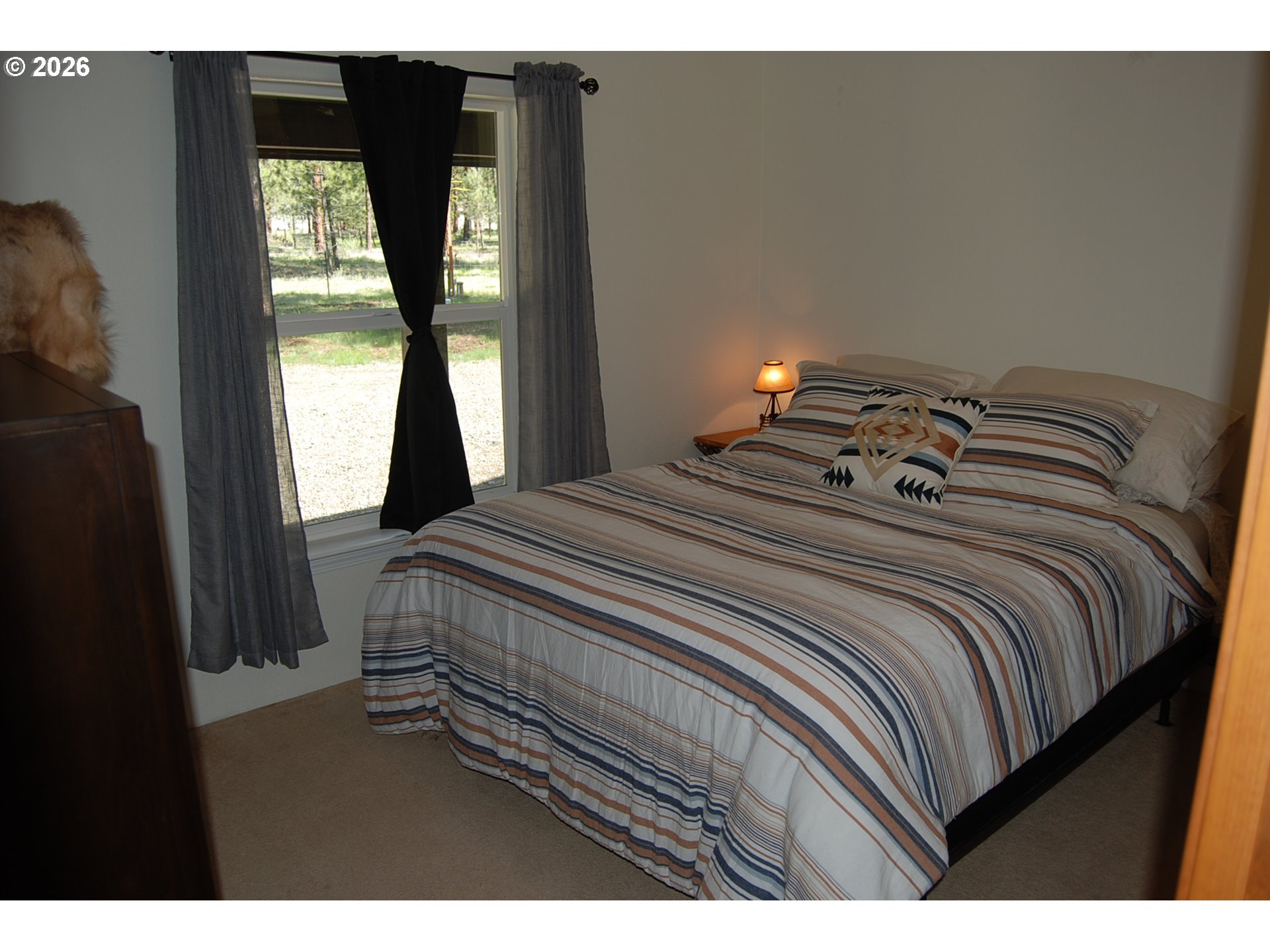 38987 Deer Creek Road Baker City, OR 97814 - Photo 23 of 45 a bedroom with a bed and a large window