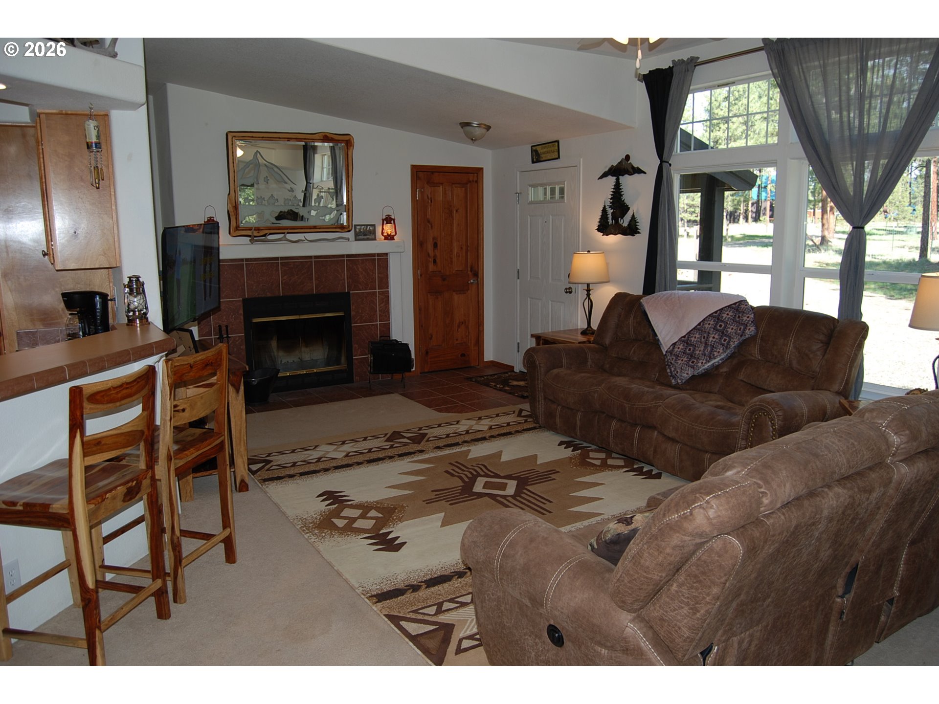 38987 Deer Creek Road Baker City, OR 97814 - Photo 4 of 45 a living room with furniture a window and a fireplace