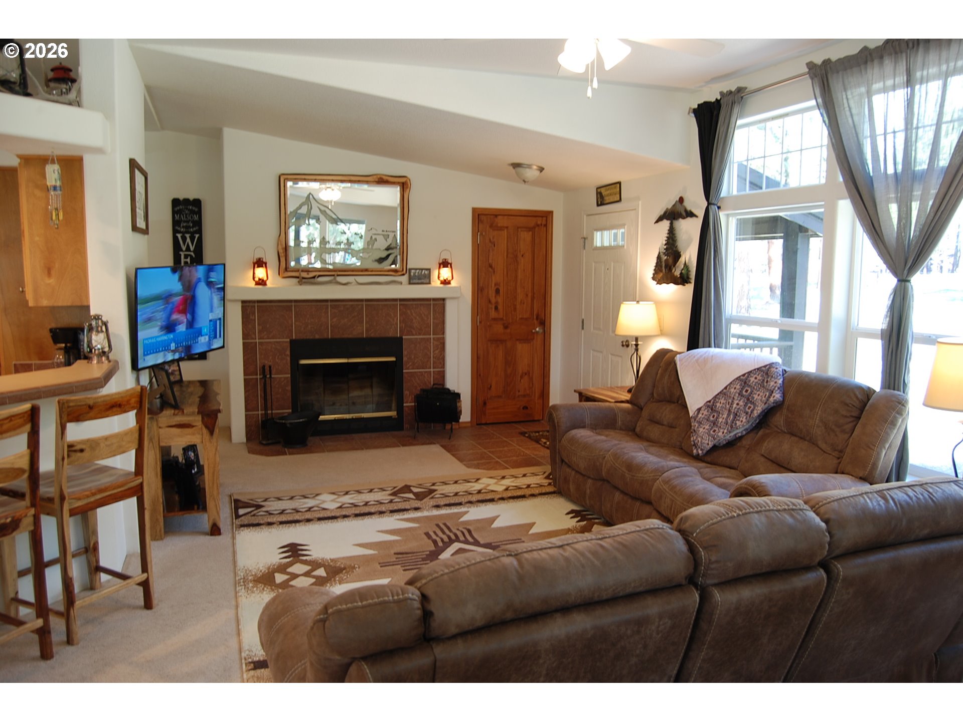 38987 Deer Creek Road Baker City, OR 97814 - Photo 5 of 45 a living room with furniture a large window and a fireplace