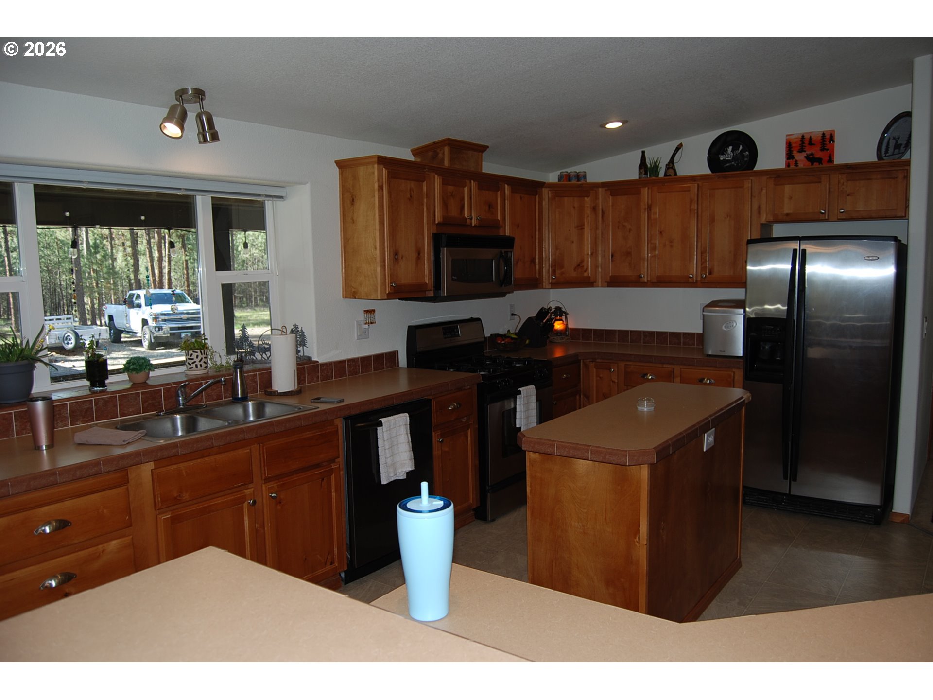 38987 Deer Creek Road Baker City, OR 97814 - Photo 9 of 45 a kitchen with stainless steel appliances granite countertop a sink a stove and a refrigerator