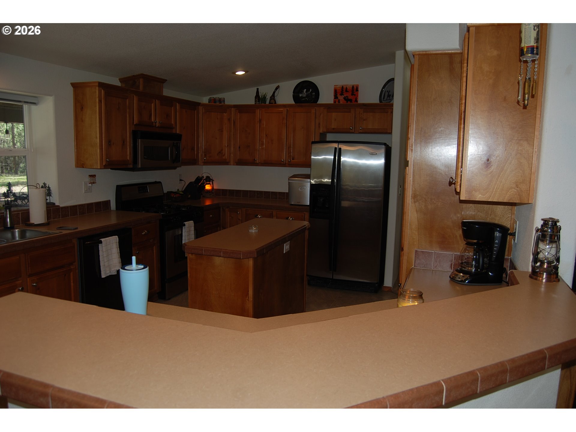 38987 Deer Creek Road Baker City, OR 97814 - Photo 10 of 45 a kitchen with stainless steel appliances granite countertop a refrigerator a sink and a stove