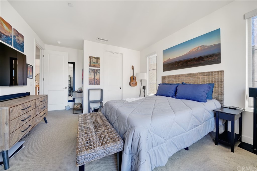 3197 Doheny Way Dana Point, CA 92629 - Photo 11 of 28 a bedroom with a large bed and a flat tv screen on dresser