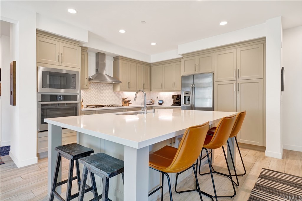 3197 Doheny Way Dana Point, CA 92629 - Photo 4 of 28 a kitchen with stainless steel appliances a table and chairs in it