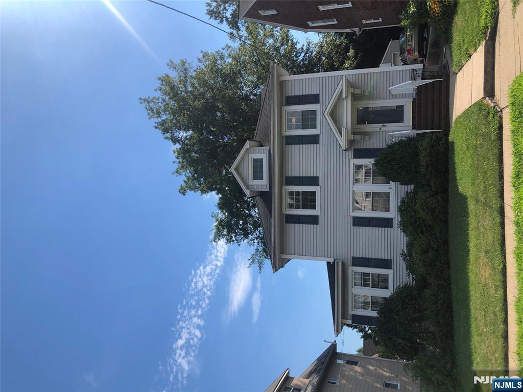 908 Linden Avenue Ridgefield, NJ 07657 - Photo 1 of 8 a front view of a house with a yard and garage
