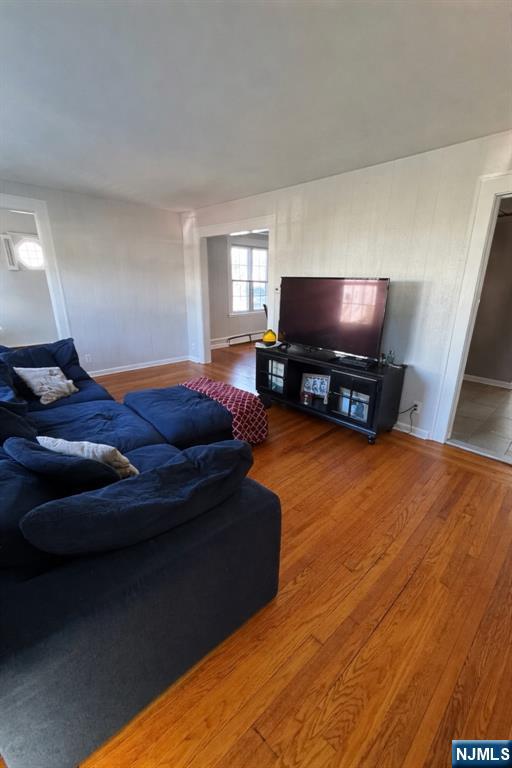 908 Linden Avenue Ridgefield, NJ 07657 - Photo 2 of 8 a living room with furniture and a flat screen tv