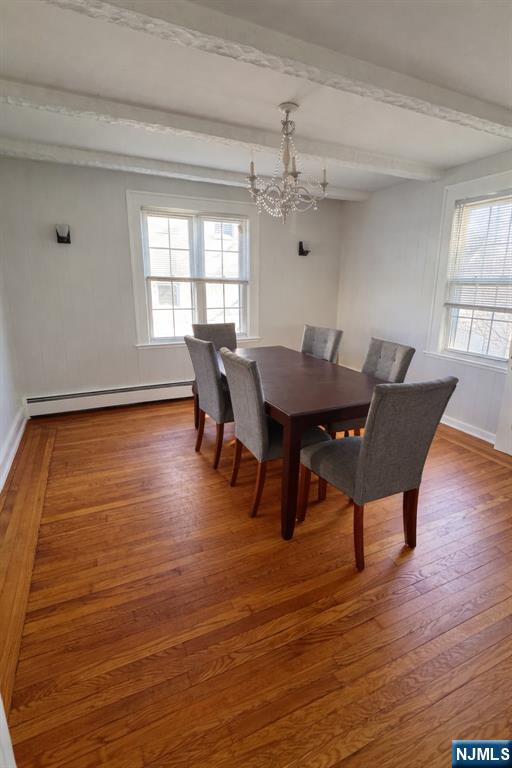 908 Linden Avenue Ridgefield, NJ 07657 - Photo 3 of 8 a view of a dining room with furniture window and wooden floor