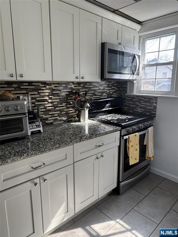 908 Linden Avenue Ridgefield, NJ 07657 - Photo 4 of 8 a kitchen with granite countertop white cabinets stainless steel appliances and a sink
